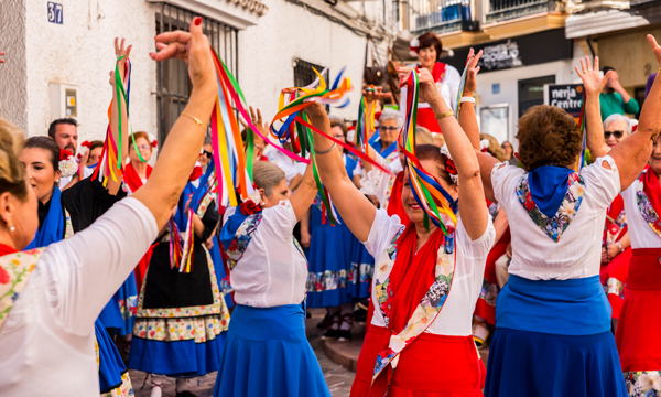 Folk dancing on the street at an annual festival held in Nerja in Spain