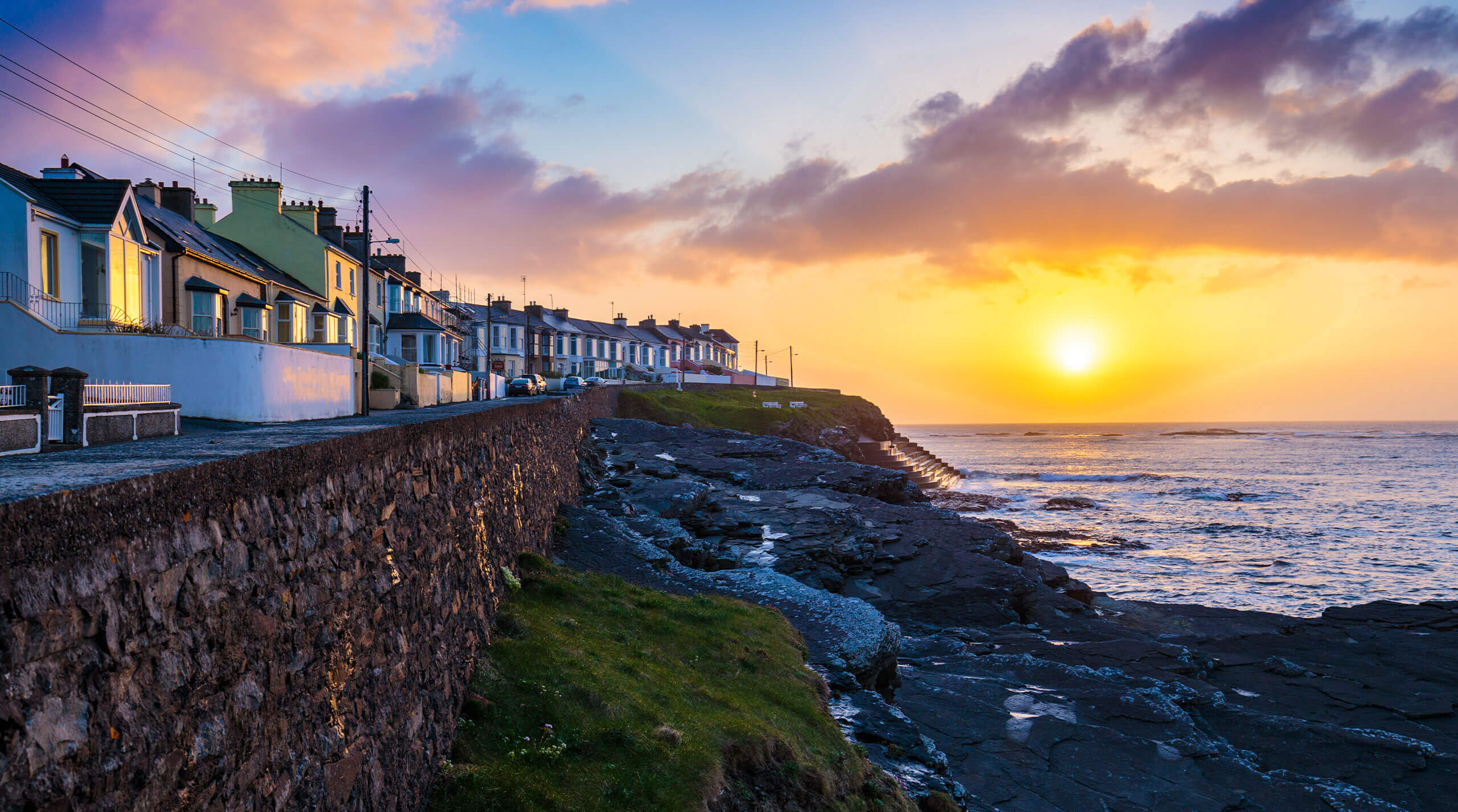 Summer short breaks holiday homes in Ireland; the town of Kilkee in Ireland and a beautiful sunset seen from the shore.