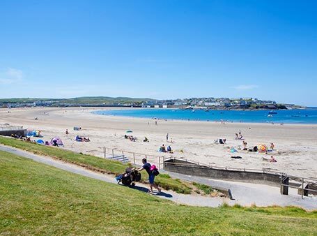 Holidaymaker enjoying a day out on Kilkee Strand located on Clare’s Wild Atlantic Way in Kilkee town County Clare