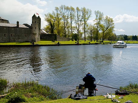Boating and fishing beside Enniskillen Castle in Fermanagh Northern Ireland