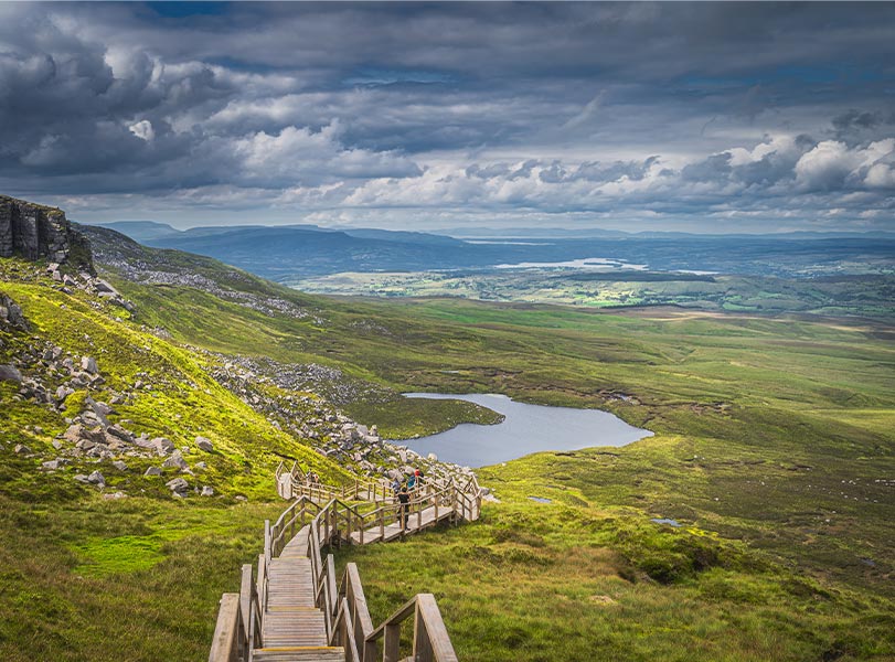 Holidaymakers hiking the steep stairs of Cuilcagh Mountain Park, known at the stairway to heaven in Fermanagh