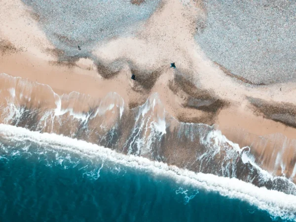 Aerial view of the Irish coast and the waves, coastal holiday homes in County Meath, Ireland.