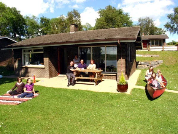 Family outside their lakeside holiday home at the Manor Cottages near Enniskillen in Fermanagh © Trident Holiday Homes