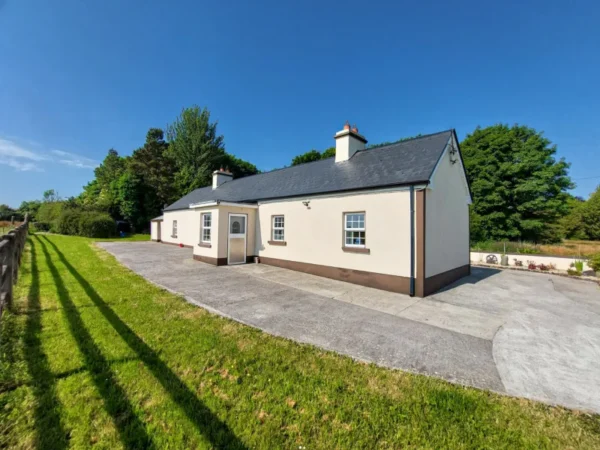 Sunny day, side view of the house, large property for rent for over 8 people in Castlerea, County Roscommon, Ireland.