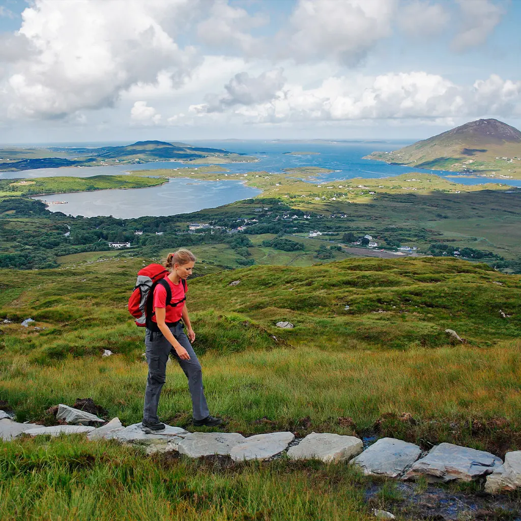 Hiker enjoying a day exploring Connemara National Park in Galway © Adobe Stock