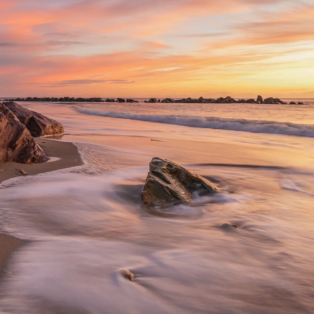 Sunrise on the shoreline at Rosslare Strand, County Wexford, Ireland.